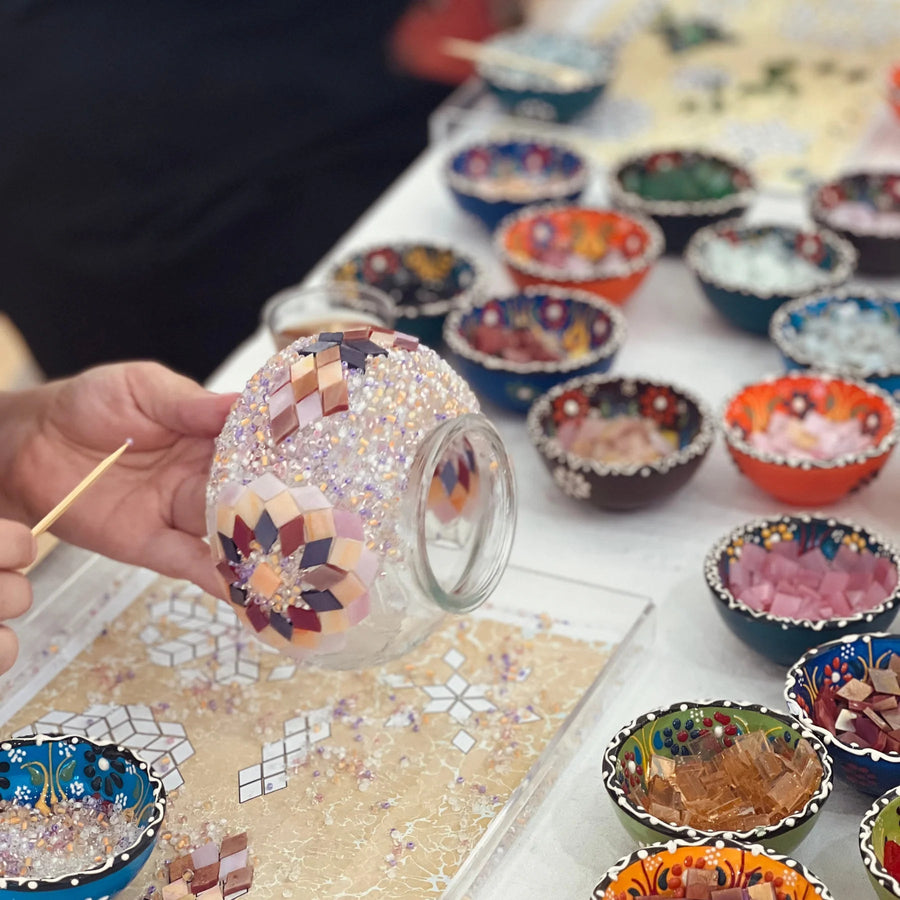 Friends arranging glass tiles for mosaic lamps together